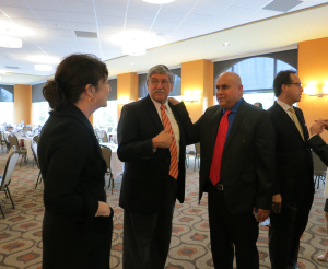 Dean Maloney, Dr. Romo, Antonio González, and Sen. José Menéndez mingle before the reception.
