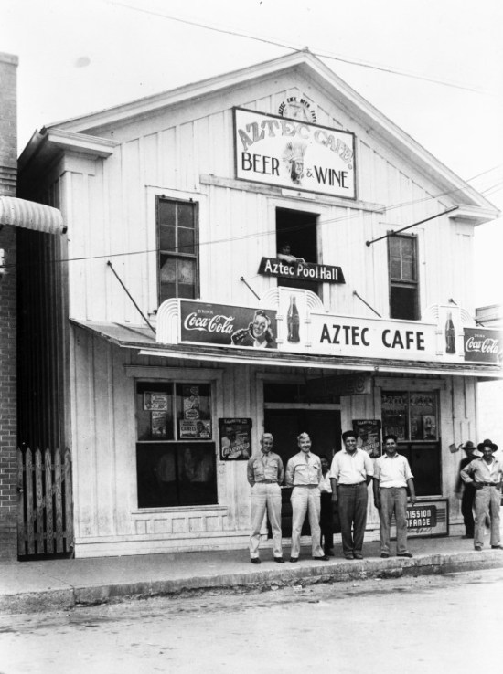 Rudy Domingez (center) and Joe Domingez pose with customers outside their café and pool hall, 18th Street, Hondo, early1940s. (General Photograph Collection, MS 362: 096-0815, courtesy of Eva Arcos ) 